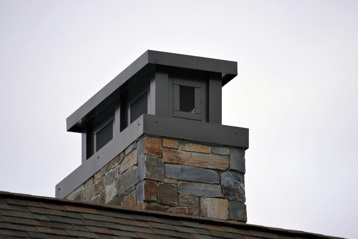 Custom copper chimney cap on a brick chimney